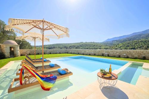 a swimming pool with a slide and a swimming pool at Blue Lake Villa Heated Pool in Georgioupoli