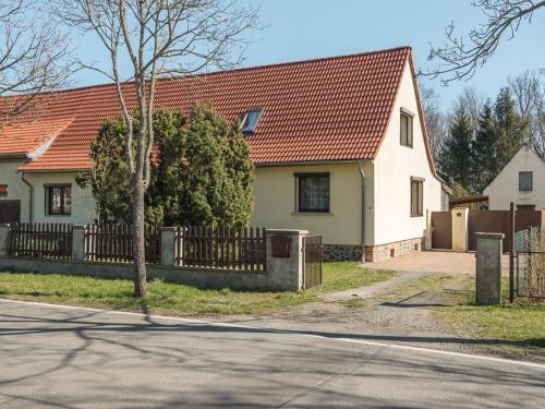 a white house with an orange roof and a fence at Alluring Holiday Home in Meisdorf with Garden in Meisdorf