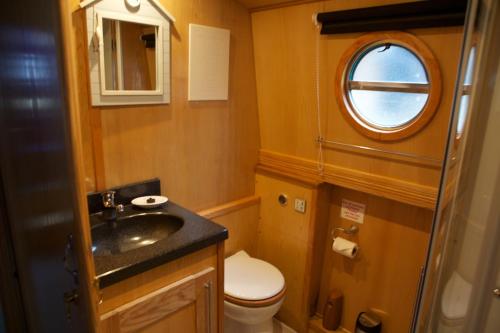 a small bathroom with a sink and a toilet at Houseboat Hotels in Sheffield