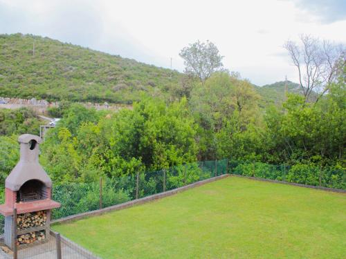 an outdoor garden with a grill and grass at Comfort Apartments Jazina in Neum