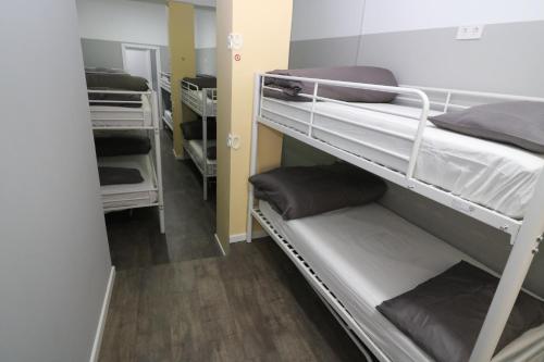 a room with two bunk beds and a hallway at Madrid Downtown Hostel in Madrid