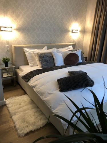 a bed with pillows on it in a bedroom at Apartamenty Pod Gwiazdami in Ustroń