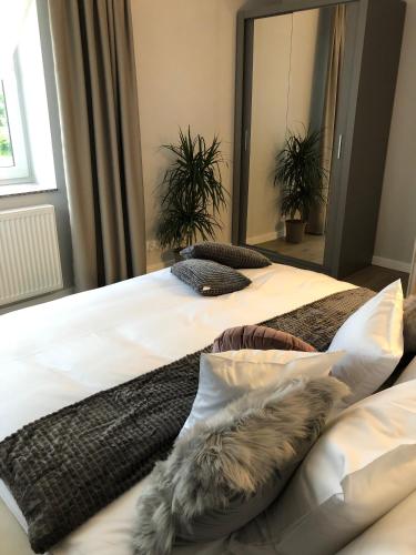 two beds in a bedroom with fur pillows on them at Apartamenty Pod Gwiazdami in Ustroń