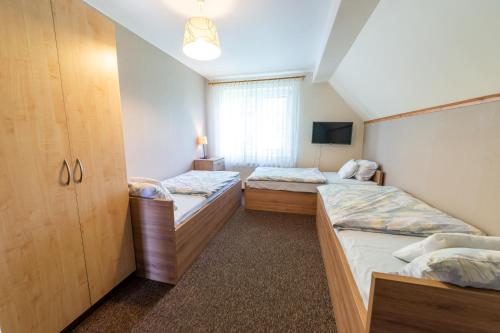 Кровать или кровати в номере Willa ATA Mikolajki