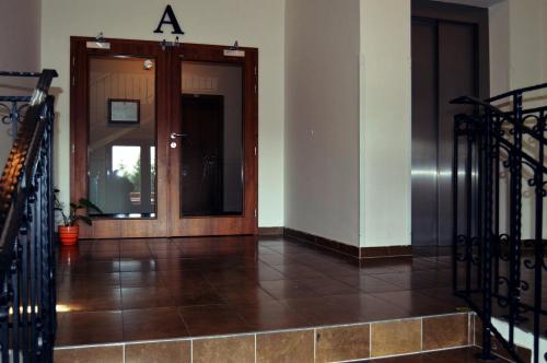 a building with a door with a sign on it at U starého jaštera in Veľká Lomnica