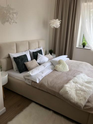 a bed with pillows on it in a bedroom at Apartamenty Pod Gwiazdami in Ustroń