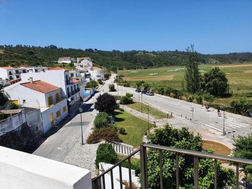 a view of a street from a balcony of a building at Hospedaria Firmino Bernardino in Odeceixe