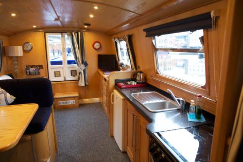 a small kitchen with a sink and a window at Houseboat Hotels in Sheffield