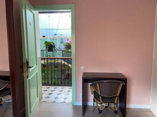 a doorway leading to a room with a table and chairs at Hotel Peninsular in Barcelona