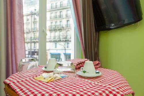 a table with a red and white checkered table cloth at Club246 Paris Saint Martin in Paris