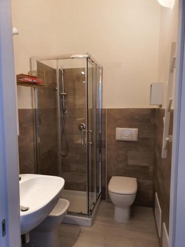 a bathroom with a shower and a toilet and a sink at CASA ARISTON in Sassari
