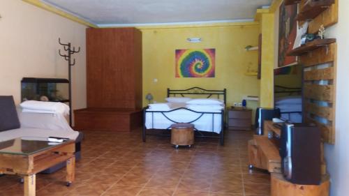 a living room with two beds and a tv at Village Life Studio in Kanakádes