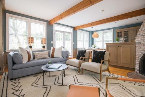 a living room with a couch and a fireplace at The Bungalow in Nantucket