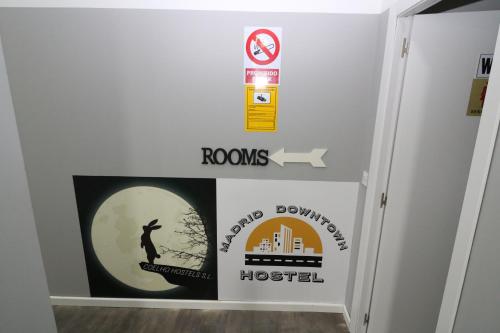 a room with a wall with signs on it at Madrid Downtown Hostel in Madrid