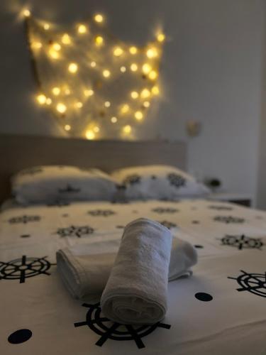 a bed with two towels and lights on it at 1oak rentals in Vir