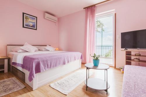 Postel nebo postele na pokoji v ubytování Apartment Kuzmanić