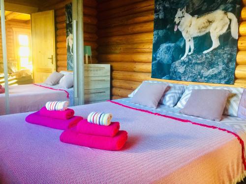a bedroom with two beds with pink pillows on them at Wild House in Las Palmas de Gran Canaria
