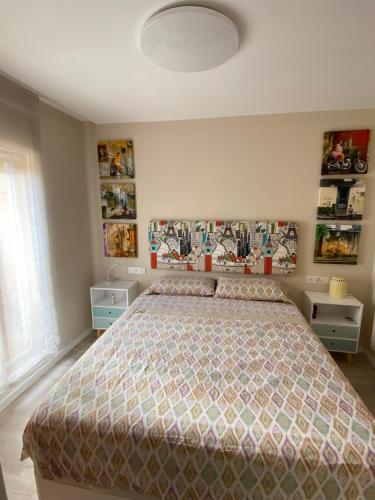 a bedroom with a bed with a comforter at La casa del perelló in Sueca
