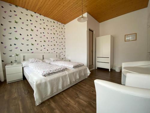 a bedroom with two beds and a wall with butterflies at Alpina Hotel in Interlaken