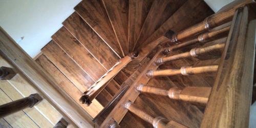 an overhead view of a wooden spiral staircase at Sóhegy Panzió in Praid