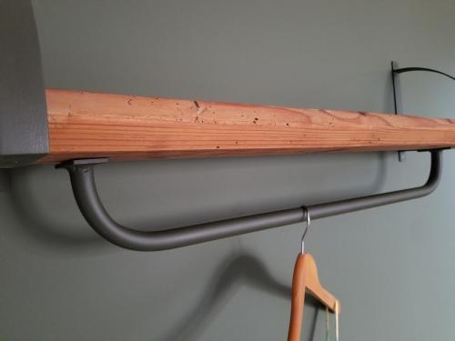 a wooden shelf with a pipe on a wall at chambre d'hôtes de charme, un temps en forêt in Westhouse