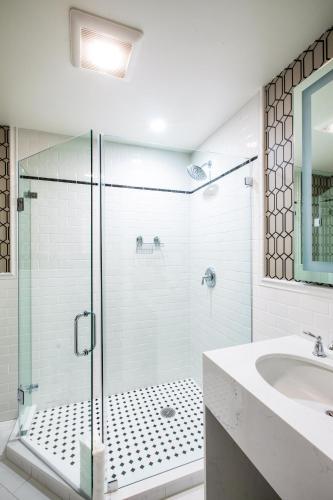 a bathroom with a glass shower and a sink at University Club of San Francisco in San Francisco