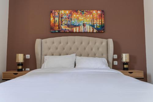 a bedroom with a bed and a painting on the wall at ROYAL PARK -George in Eilat