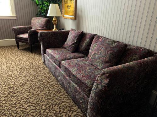 a living room with a couch and a chair at Celebrity Boutique Hotel in Deadwood