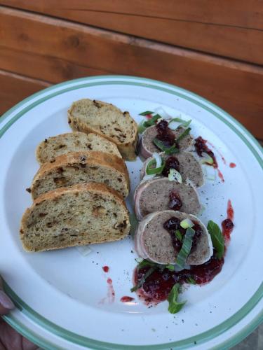 a plate of food with bread on a table at Kameňácká myslivna in Moravany