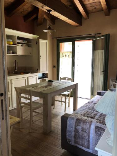 a kitchen and dining room with a table and a bed at B&B La Piazzetta in Castiglione dei Pepoli
