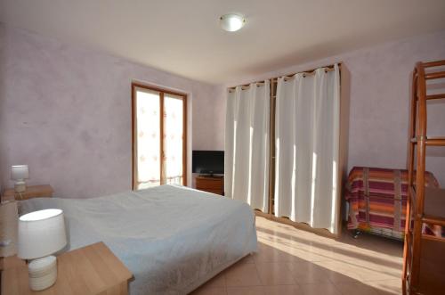 a bedroom with a white bed and a window at SweetHome Fabio&Stefy in Guidonia