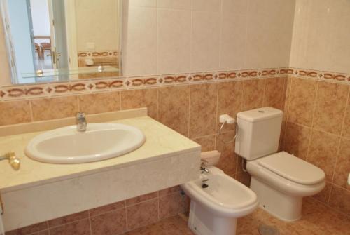 a bathroom with a sink and a toilet and a mirror at Great 2 Bedroom Apartment Near Puerto Banus in Marbella