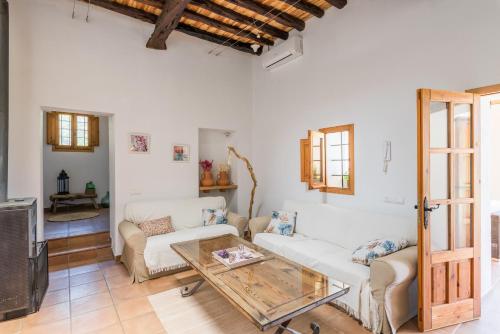 a living room with a couch and a table at Casa rural es Murtà in Santa Eularia des Riu