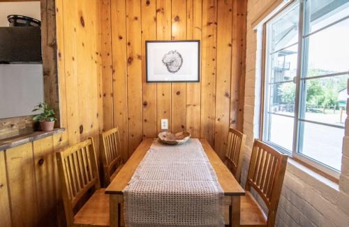 a wooden table in a room with a window at Lake Front Cabins in June Lake