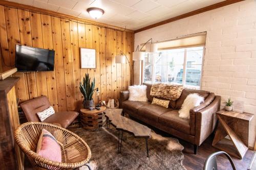 a living room with a couch and chairs at Lake Front Cabins in June Lake