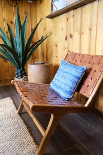 a wooden chair with a blue pillow sitting on it at Lake Front Cabins in June Lake
