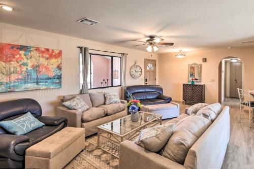 a living room with couches and a table at Lake Havasu City Home with Views 3 Mi to Marina! in Lake Havasu City