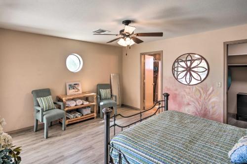 a bedroom with a bed and two chairs and a ceiling fan at Lake Havasu City Home with Views 3 Mi to Marina! in Lake Havasu City