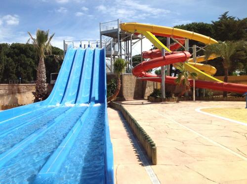 a large swimming pool with a water slide at TOPSUN Argelès La Sirène 3 bedroom Max 4 adulte et 2 des ses enfants in Argelès-sur-Mer