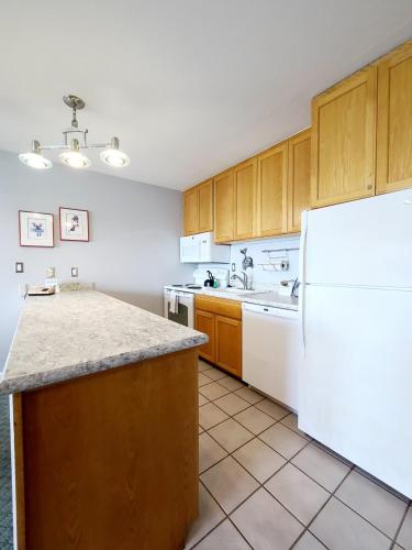 a kitchen with white appliances and a white refrigerator at Embarcadero Resort in Newport