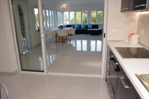 a kitchen with a glass door leading to a living room at Villa Lucia with private pool and a whirlpool in Vis