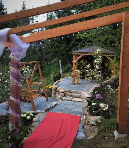 a red carpet on a stone walkway with a wooden arch at Armand Heights in Ganges