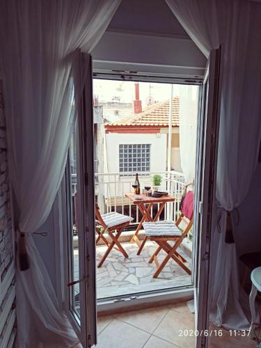 an open door to a patio with a table and chairs at Apartment Marina 2 in Asprovalta