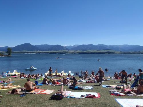 a group of people on the beach at a lake at Amis apartmán 1 in Liptovský Mikuláš