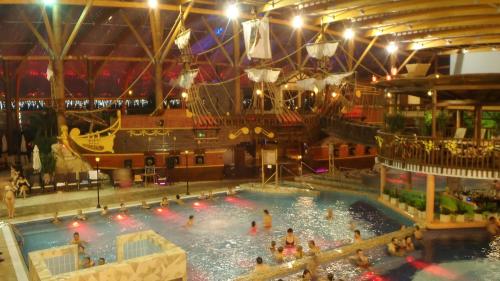 a large indoor swimming pool with a pirate ship in it at Amis apartmán 1 in Liptovský Mikuláš