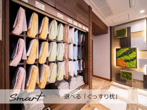 a room with a closet filled with shoes at Super Hotel Sendai Airport Inter in Natori
