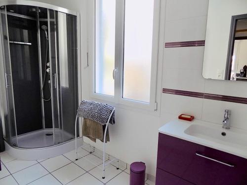 a bathroom with a shower and a sink at Les Sables d'or in Agon-Coutainville