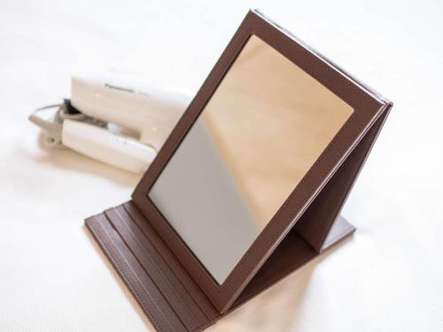 a mirror in a wooden frame sitting on a table at Super Hotel Sendai Airport Inter in Natori