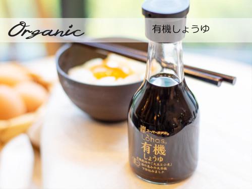 a bottle of wine sitting next to a bowl of food at Super Hotel Sendai Airport Inter in Natori