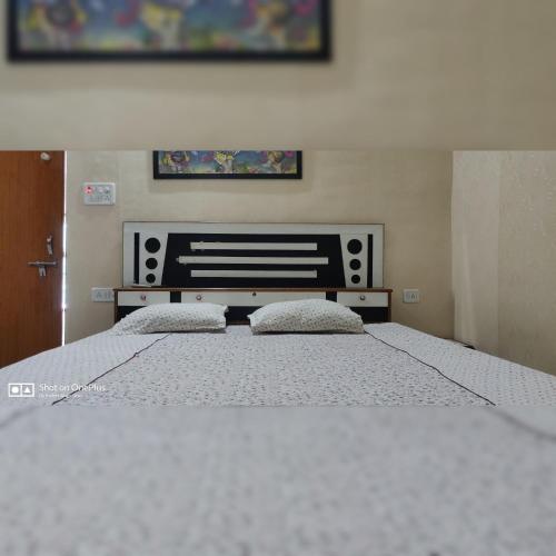 a bedroom with a large bed with two pillows on it at Couple Friendly Hotel - Sunset in Orchha